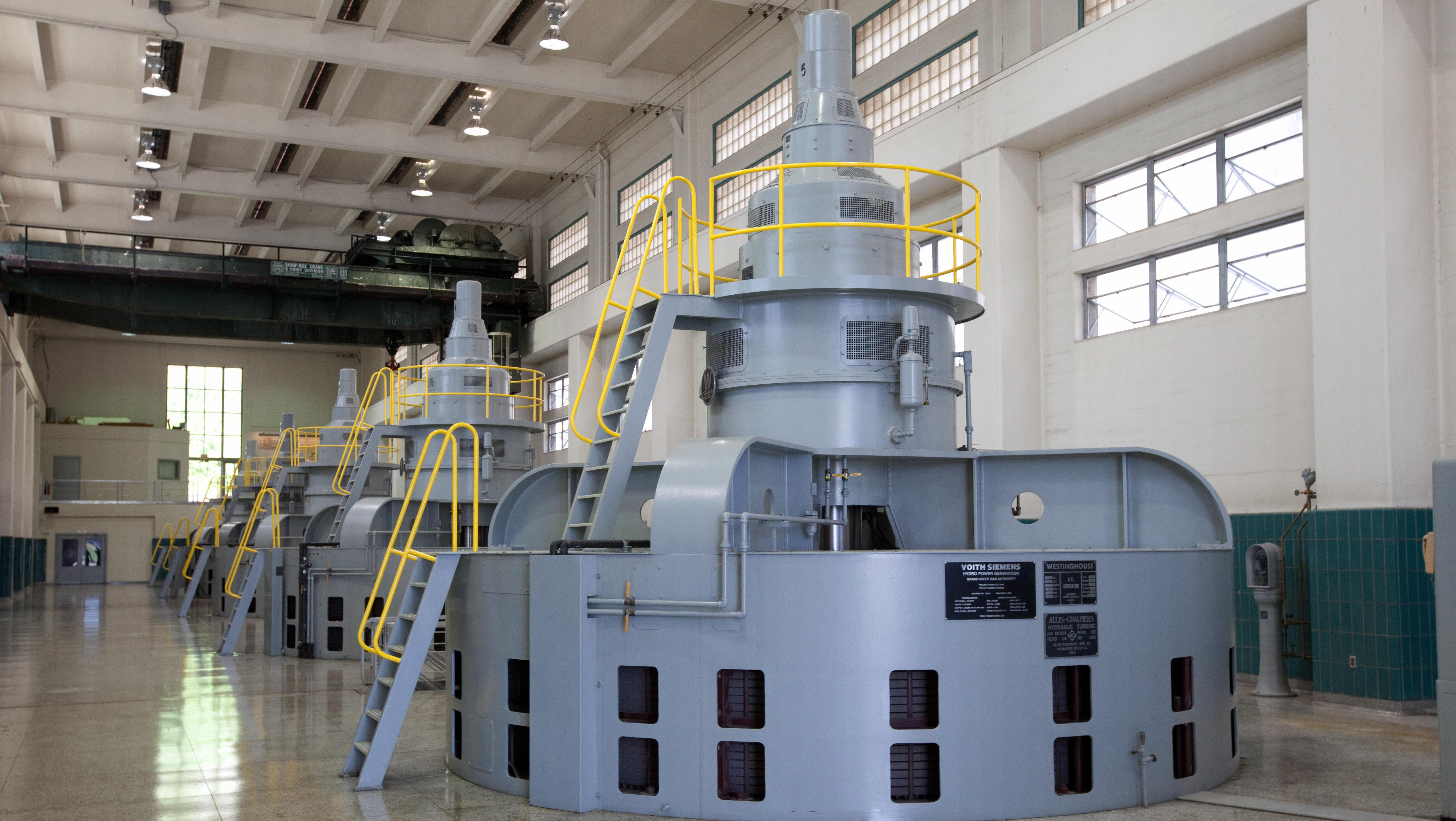 Powerful source... A view of the across the hydroelectric turbine-generator floor inside the Pensacola Dam powerhouse. This view, and the purpose of these generators - to turn the power of water into hydroelectricity - has not changed in nearly 90 years.