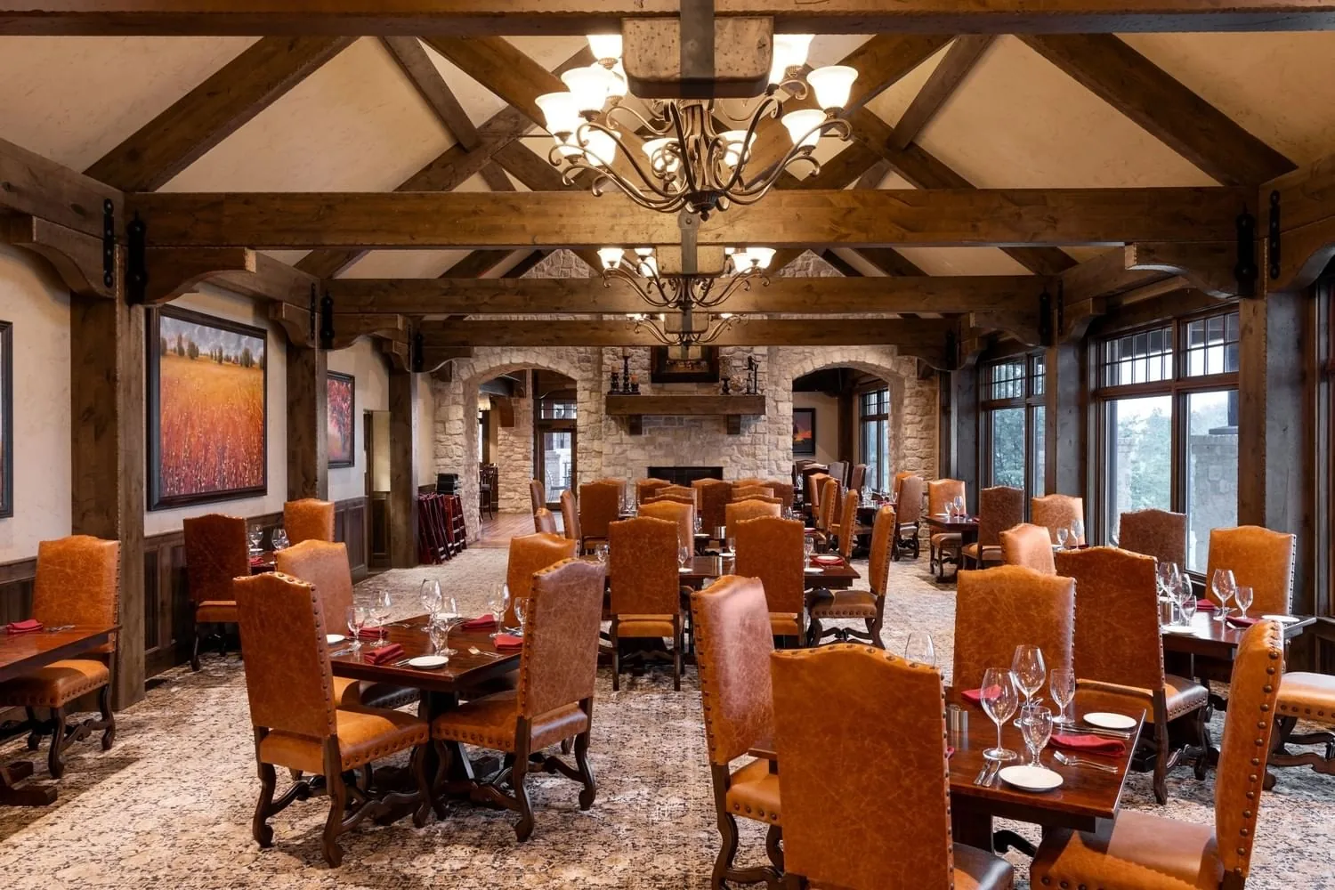 The Summit dining room with vaulted wooden beams, chandeliers and leather chairs at Shangri-La Resort